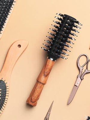 Hair-stylist-tools-on-tan-background